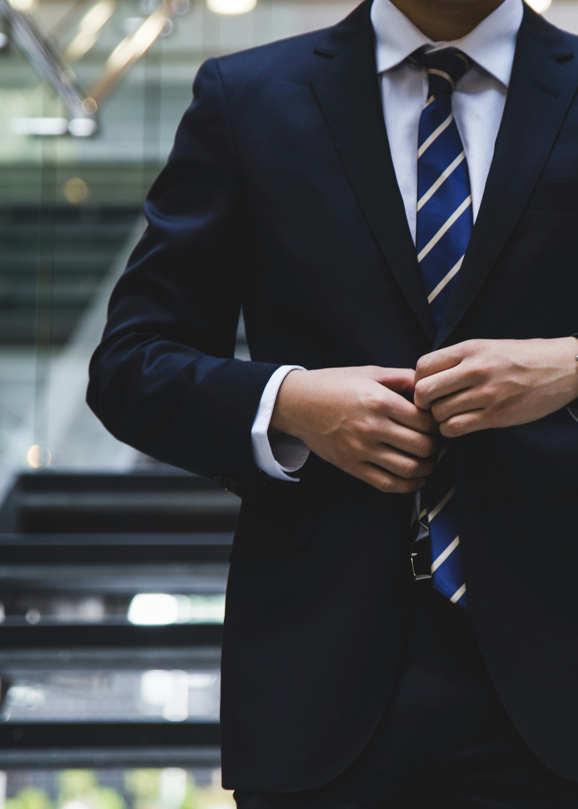 Professional man in suit and tie on staircase.
